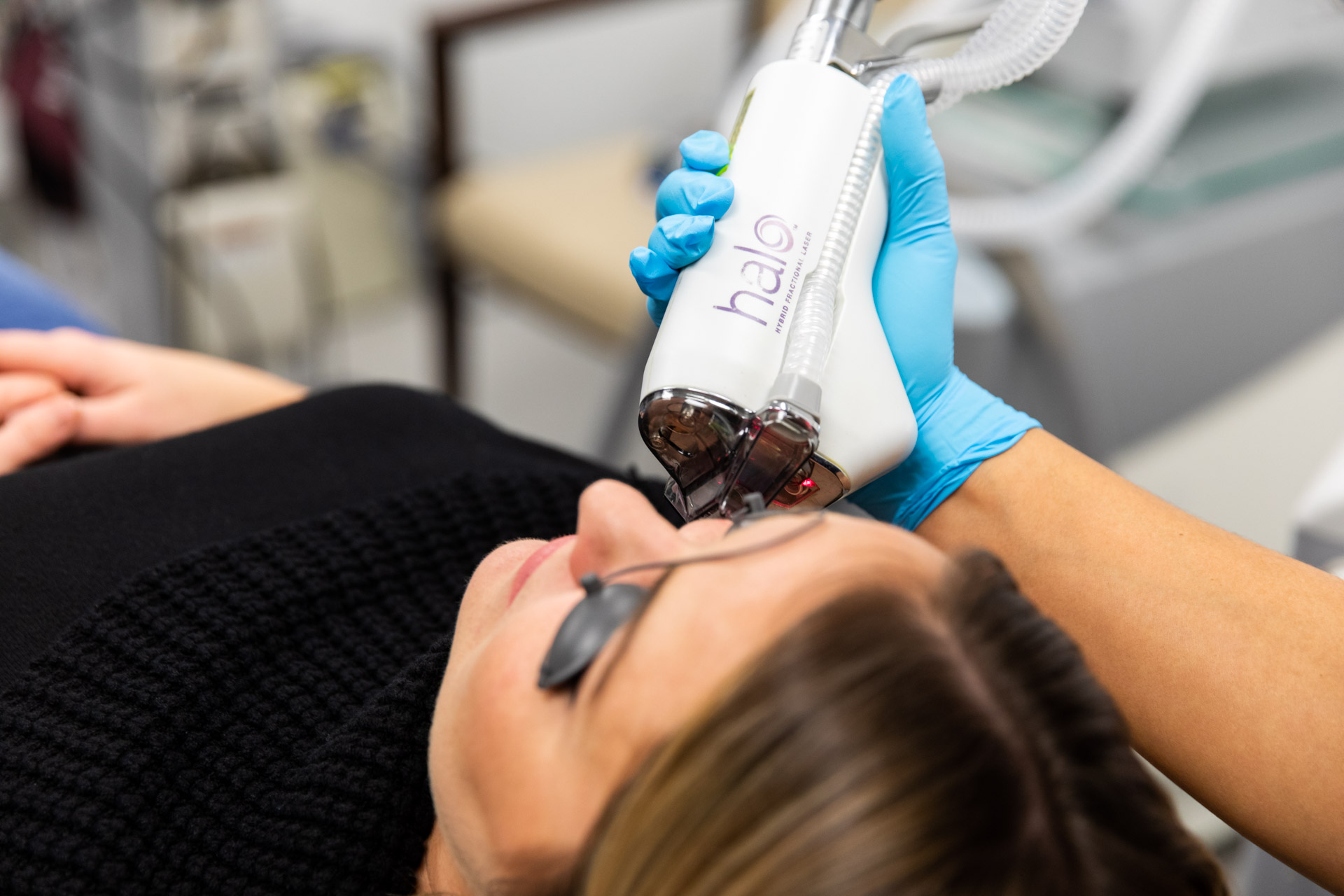 A practicioner performs a HALO treatment, one of our many low downtime laser treatments