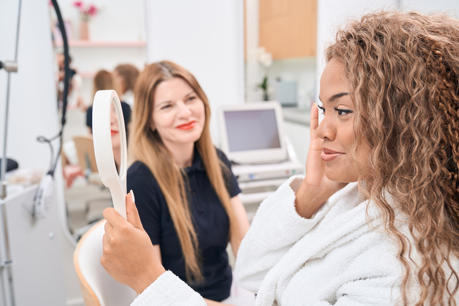 A woman smiles after low downtime laser treatments